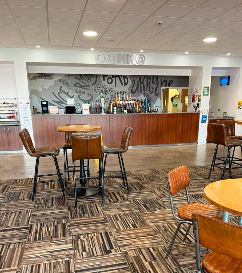 Multiple tables and seats in bar area of Ashford International Truck Stop