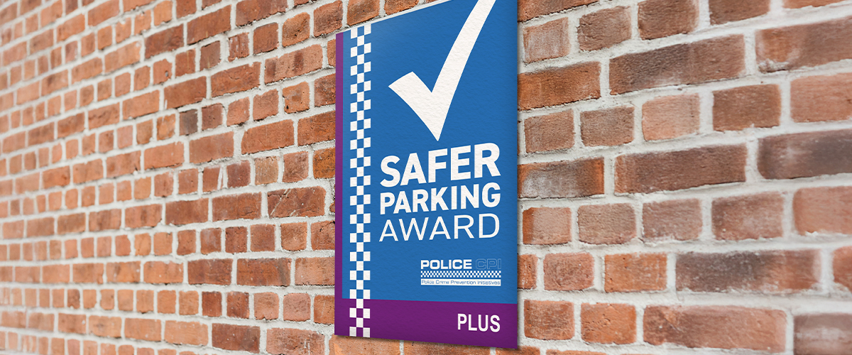 Safer Parking Plus award displayed on brick wall in car park