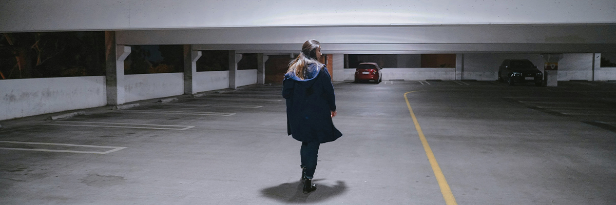 Woman walking alone in multi-storey car park