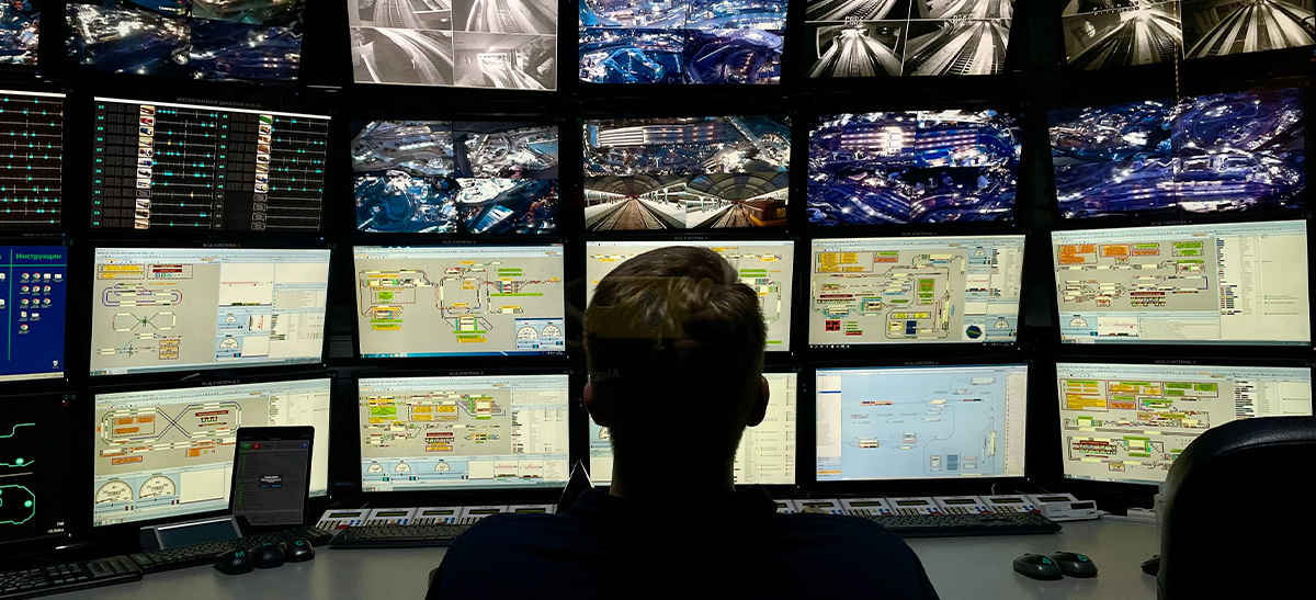 Person monitoring various cctv footage monitors