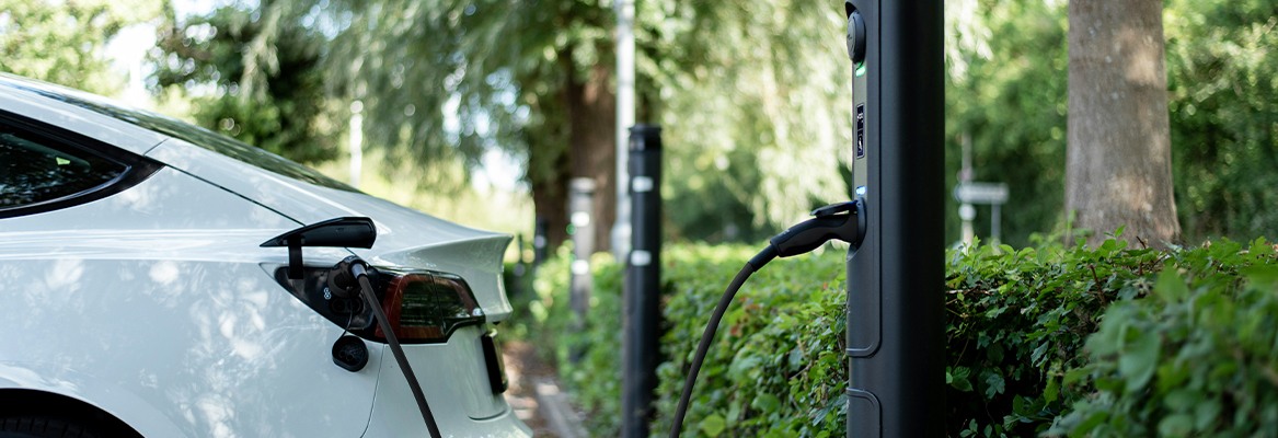 Electric vehicle at an EV charging bay in a car park